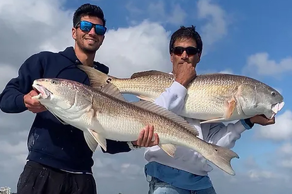 two men holding fish