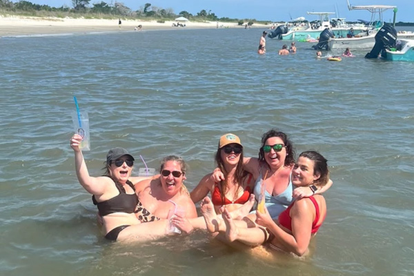 women posing for a photo in the ocean